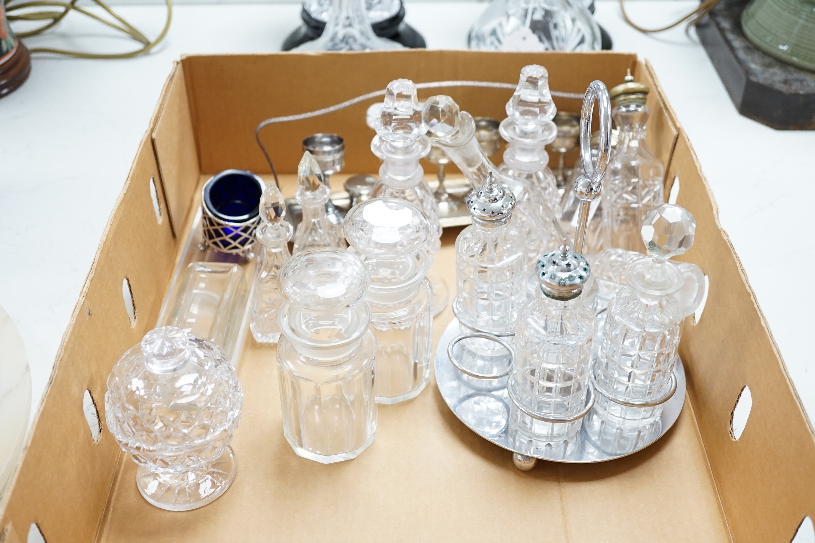 A pair of cut glass vases on stands two decanters and a collection of small glass bottles and silver plate etc., vases 24.5cm